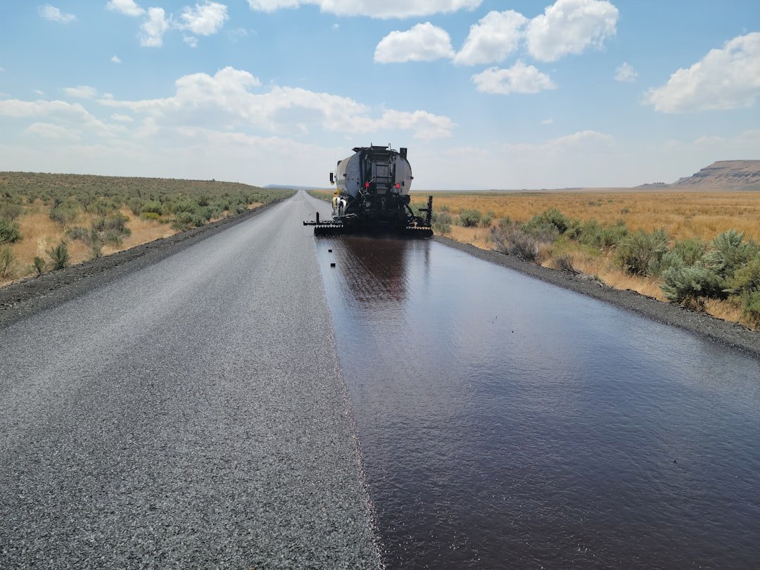 a-large-truck-driving-down-a-wet-road-kaovunv9w0